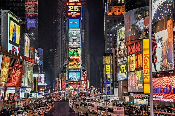Foto noturna da Time Square, em Nova York, EUA. Ela demonstra um ambiente dominado pelo outbound marketing, com diversos painéis eletrônicos de publicidade.